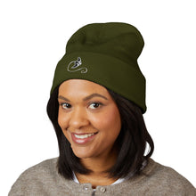 Load image into Gallery viewer, Person wearing a green beanie with a logo on a white background