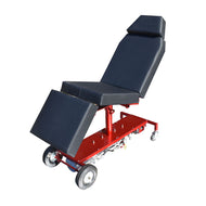 A red and black tattoo chair with an electric hydraulic system, solid rubber wheels, and adjustable armrests.
